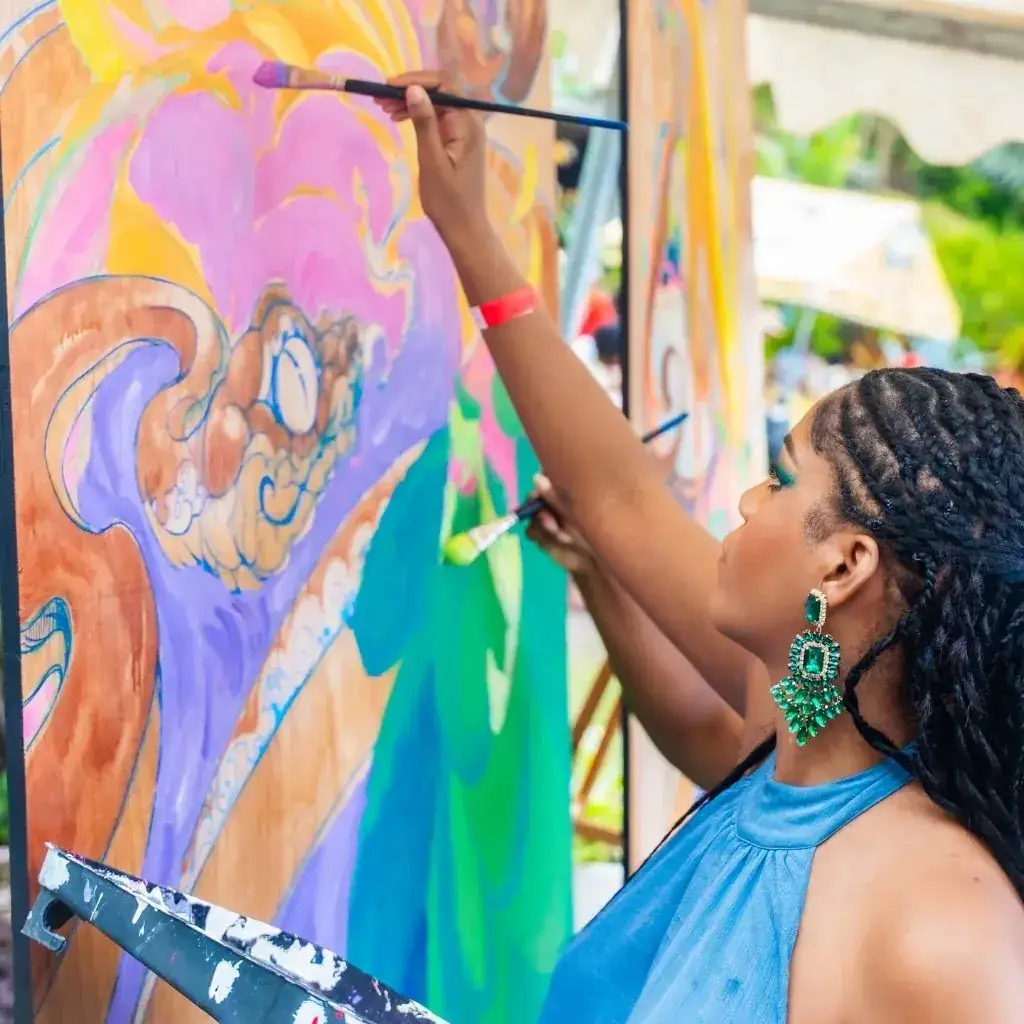 An artist creating a colourful live painting at the Jazz & Arts festival
